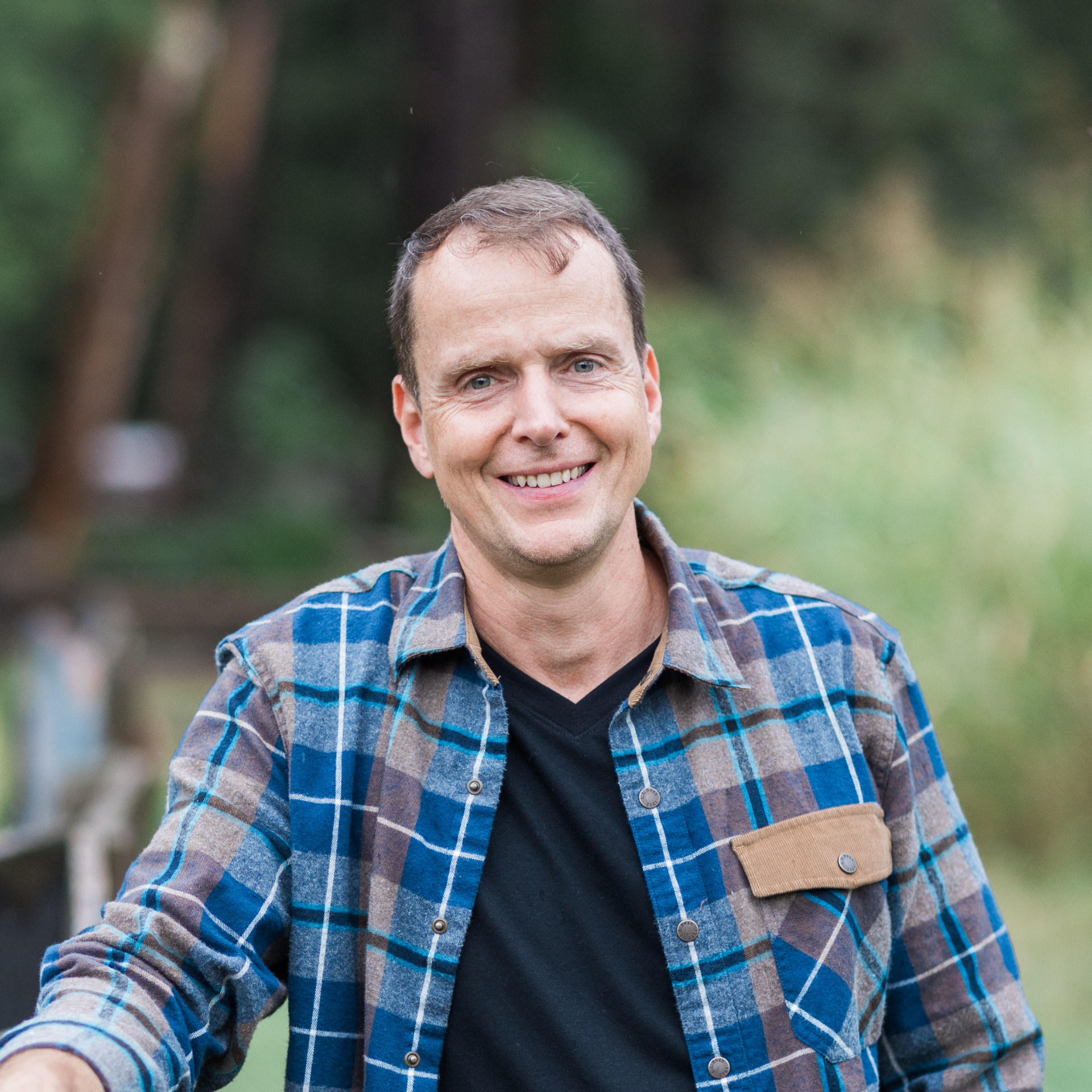 Aaron Hartman MD leaning against a fence